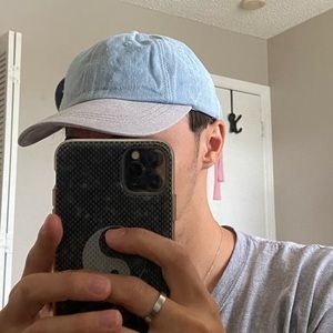 Light wash blue denim and gray baseball hat.